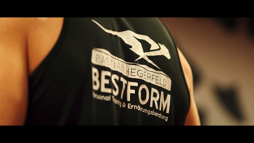 Schwarzes Sporttop mit dem Text „BESTFORM“ und einer stilisierten Figur.